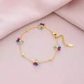 Gold stainless steel bracelet with five multicolored crystal flowers on pink fabric - Colorful