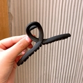 Matte black large shark hair claw clip for women with a minimalist aesthetic design - Cross Design