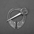 Detail view of silver Celtic knot brooch with intricate woven patterns and metal pin closure - D-180 Antique Tin