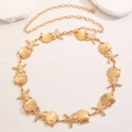 Detail of bohemian gold waist chain featuring starfish, shells, and faux pearls on a belt - Gold Starfish Seashell Style