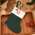 Green knitted Christmas stocking with red embroidered letter M and white cuff decoration - Letter M