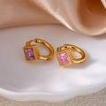 Detailed shot of gold star hoop earrings featuring square pink zircon in ceramic dish - Rhombus Zirconia / Pink