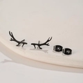 Close-up of matte black stainless steel reindeer antler earrings with butterfly backs - Black