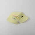 Detail of embroidered bows and brand label on a light yellow kids sun hat - Kids One Size / Light Yellow