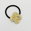 Elastic black hair tie featuring a hammered gold heart metal charm on a white background - Shiny Gold - Clover