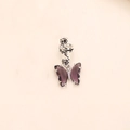 Macro detail of silver spiral dreadlock ring with a purple crystal butterfly pendant - Purple Crystal Silver