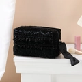 Quilted black makeup bag with glossy finish and zip closure on a white vanity - Octagonal Pouch / Black