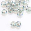 Macro shot of 8x10mm round iridescent glass beads with holes for DIY jewelry making - Transparent Green