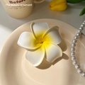 Exquisite white and yellow frangipani flower hair clip on a decorative ceramic tray - Plumeria Hair Clip Medium