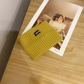 Minimalist wide knitted sport headband in mustard yellow color with RANK logo tag - Yellow