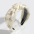 Detail of cream fabric headband with imitation pearls and white enamel bow accents - Light Yellow