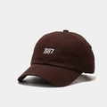 Detailed close-up of dark brown cotton baseball cap with white 1987 embroidery - M (56-58cm) / Brown