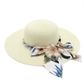 Close-up of beige straw sun hat featuring white pearl beads and floral ribbon bow detail - M (56-58cm) / Creamy White