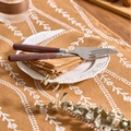 Caramel colored linen napkin with white floral patterns for American retro dining setups - Orange Background Curved Flower