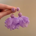 Close-up of purple raffia ball and layered chiffon petal flower drop earrings for women - Purple