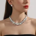 Close-up of white crystal teardrop necklace and earring set on model with starburst reflections - Teardrop White Crystal Style + Earrings