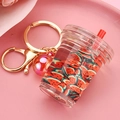 Detail of creative watermelon tea cup keychain with liquid filling and gold metal ring - Red Cup