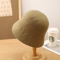 Winter wool felt bucket hat in olive green shown on a wooden stand for women - M (56-58cm) / Khaki