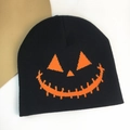 Black Halloween knitted beanie featuring an orange Jack-o'-lantern pumpkin face pattern - Pumpkin Expression / Black & Orange