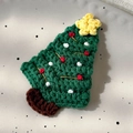 Detailed view of a handmade crochet Christmas tree hair clip with red and white accents - 26228E Green Christmas Tree Star BB Clip