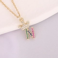 Macro shot of 18K gold crown necklace with colorful zircon letter N pendant - Letter N Style