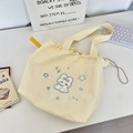 Macro shot of cream yellow canvas drawstring tote featuring embroidered blue cartoon rabbit - Cute Rabbit (Cream Yellow)