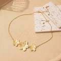 Elegant gold flower necklace with three petals and a fine chain on a sandy background - Elegant Flower Pendant (rg)