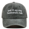 Close-up of Put It On My Hubby's Tab white embroidery on washed dark grey cotton cap - Adjustable / Army Green