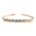 Close-up of golden open bangle featuring nine heart-shaped elements with pavé set crystals - Heart Bangle
