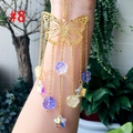 Detailed close-up of golden butterfly suncatcher with colorful floral beads and stars - Gold Butterfly Rose Star