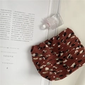 Detailed macro view of the textured pleated chiffon fabric with brown floral pattern - Brown Floral Shrapnel Bag
