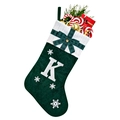 Detail of green velvet Christmas stocking with white knit cuff and embroidered letter K - Green K