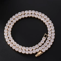 Detailed macro view of gold tennis chain featuring dense square zircon inlay and clasp - Tennis Chain / Gold