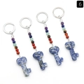 Set of four 7-chakra heart key shaped natural stone keychains on white background - Sodalite