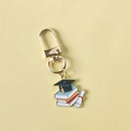 Graduation cap keychain with colorful books and diploma scroll in golden alloy finish - Style 1 (Gate Buckle)