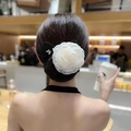 Close-up of white fabric camellia flower hair bun maker with bow and rhinestone detail - Peony Beige