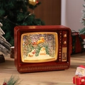 Détail macro du téléviseur rétro boule à neige avec scène de Noël et paillettes scintillantes - Maison de Noël / Rouge