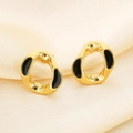Detail of geometric gold-plated earrings with black enamel inlay on silk background - Irregular Hoop Style (KE114512-K)