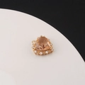 Macro shot of gold heart pendant with orange-brown gemstone and zircon stones - Champagne