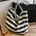 Minimalist black and white striped canvas tote bag shown in a classic shoulder bag style - Black