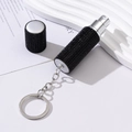 Close-up of portable black rhinestone perfume atomizer with keychain and silver spray nozzle - 5ml / Black
