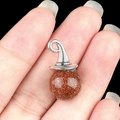 Brown sandstone crystal pendant with silver wizard hat detail held on fingertips - Gold Sand Stone (Synthetic)