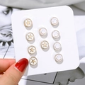 Set of 6 pairs of gold-plated star and smiley face stud earrings on a display card - Smiley Star