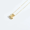 Polished gold bubble letter E pendant necklace with sleek metallic finish on white background - Letter E
