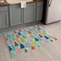 Detail of Christmas doormat with colorful tree patterns on blue background in a kitchen - Christmas Doormat-7