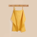 Close-up of ginger waffle cotton nursing cover with adjustable strap on wooden hook - Ginger (Wooden Ring)