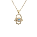Gold Hamsa hand necklace with evil eye pendant and zircon stones on white background - Hamsa Hand Evil Eye