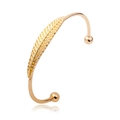 Elegant gold open cuff bracelet featuring a detailed feather design and spherical ends - Feather Open / KC Gold
