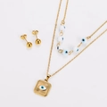 Detail of gold layered necklace with square eye pendant and matching ball stud earrings - Gold White