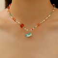 Colorful beaded necklace with a blue bird pendant shown on a model neck - Blue Bird Beaded Style (Light KC Gold X316)